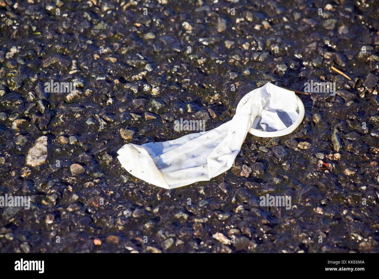 used condom discarded on a street in the uk Stock Photo