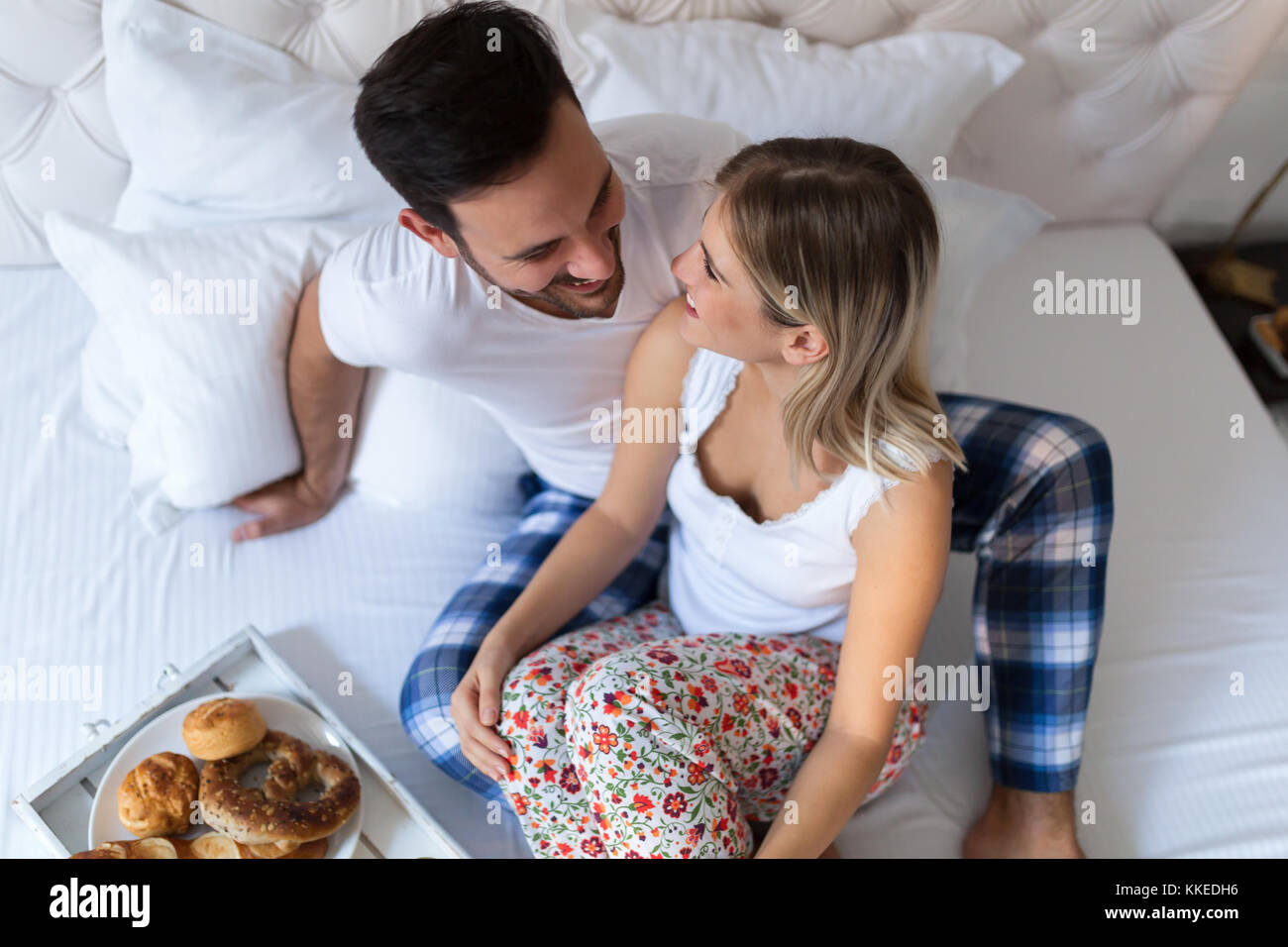 Young attractive couple having breakfast in bed Stock Photo