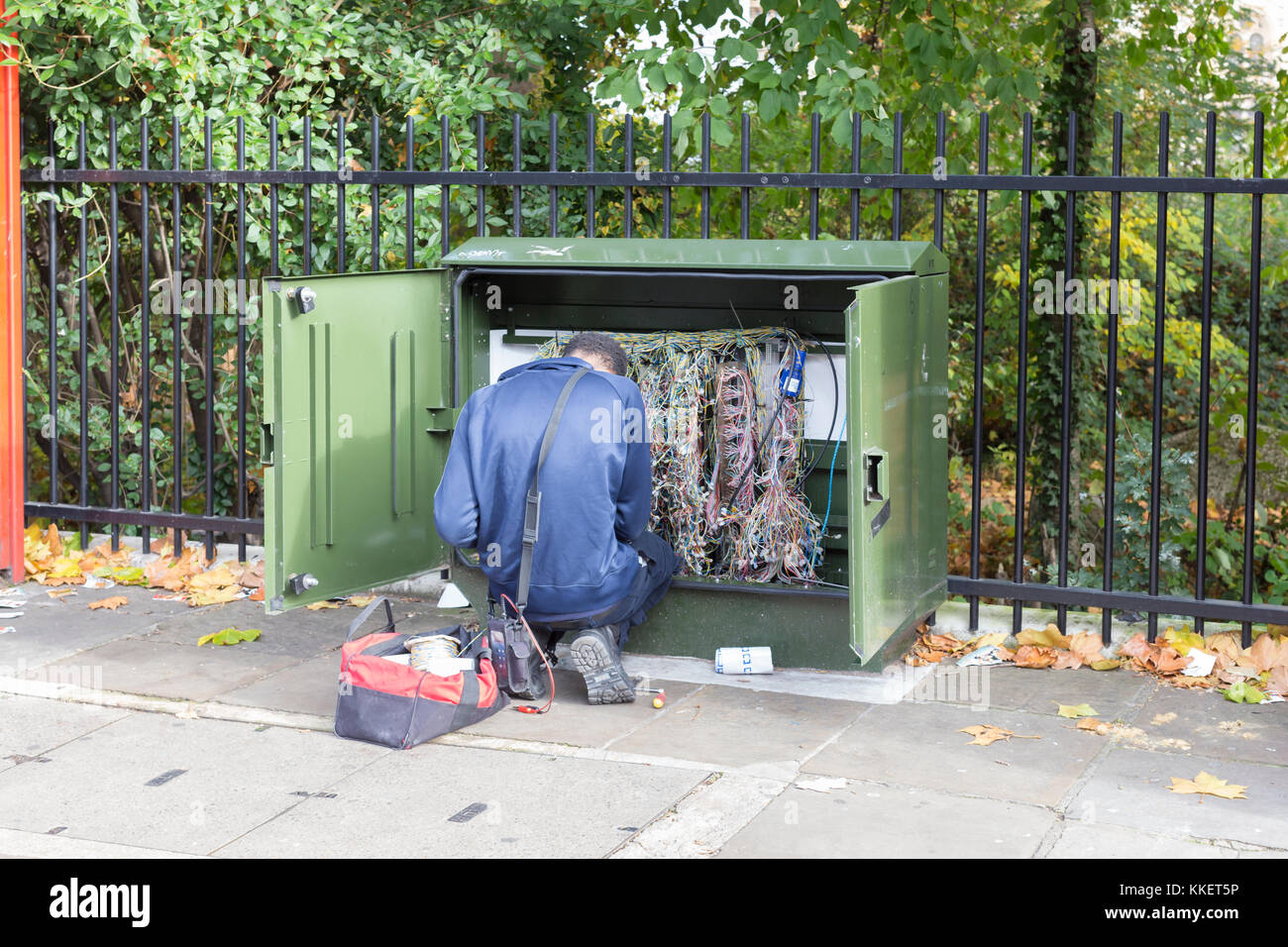 Telephone technician repairing a switch box, London, England Stock Photo