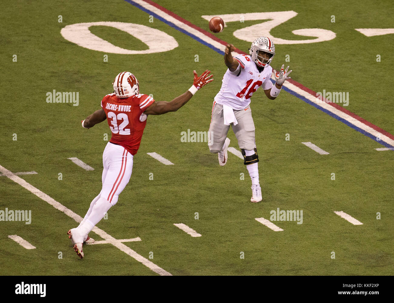 Indianapolis, Indiana, USA. 02nd Dec, 2017. Ohio State quarterback J.T. Barrett (16) passes the ball as Wisconsin linebacker Leon Jacobs (32) defends during NCAA Football game action between the Ohio State Buckeyes and the Wisconsin Badgers at Lucas Oil Stadium in Indianapolis, Indiana. Ohio State defeated Wisconsin 27-21. John Mersits/CSM/Alamy Live News Stock Photo