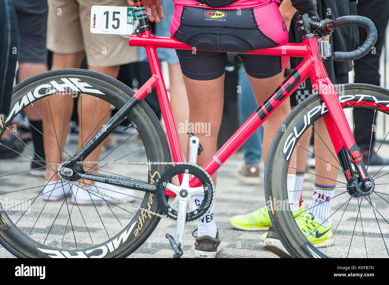 Close of of Fixie Bike and Girls Bottom, one of the riders and the Redhook cycle crit race London Stock Photo