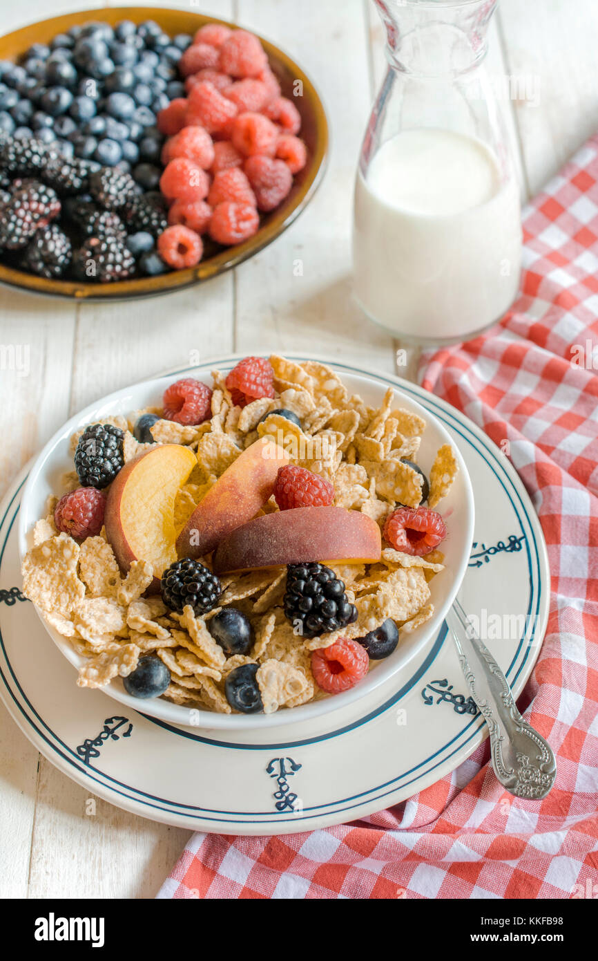 Corn flakes and berry fruits on the bowl on wooden background,selective focus Stock Photo
