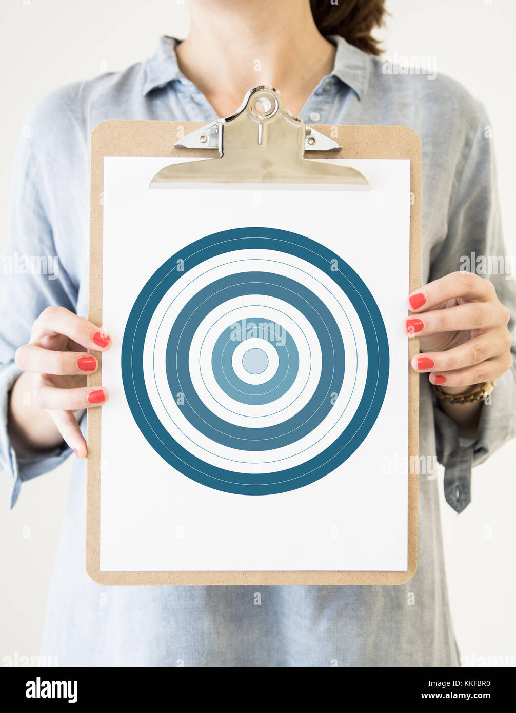 woman holding a clipboard with bullseye Stock Photo