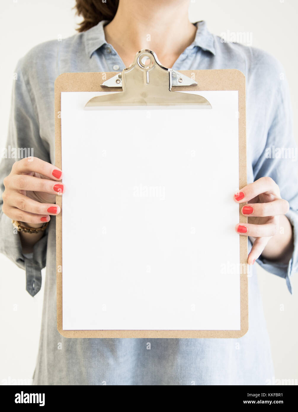 woman holding a clipboard with blank papersheet Stock Photo