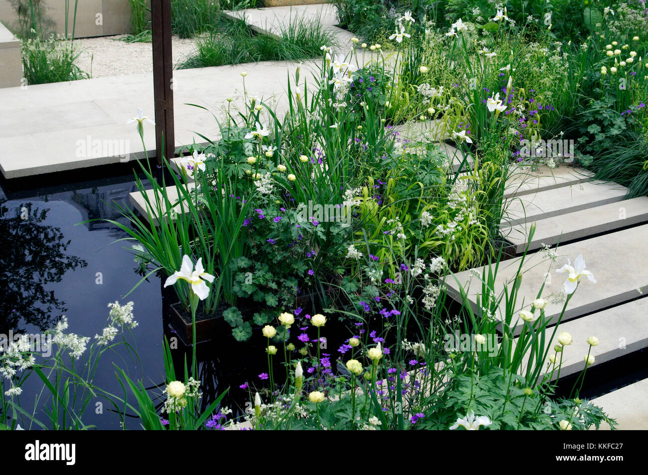 Calm and peceful flower planting with water feature in a modern garden Stock Photo