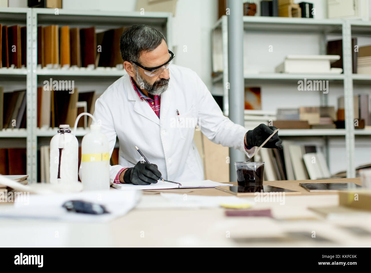 View at engineer in the laboratory examines ceramic tiles Stock Photo