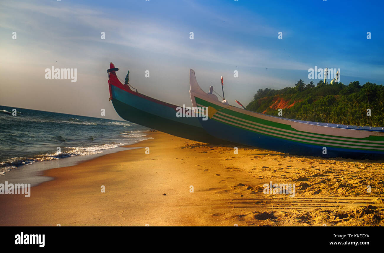 Painted and carving boats of Indian fishermen on beaches of Kerala. Love attitude to work and life (Indian civilization) Stock Photo