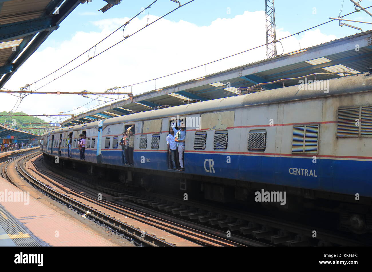 People travel by City train in downtown Mumbai India. Stock Photo