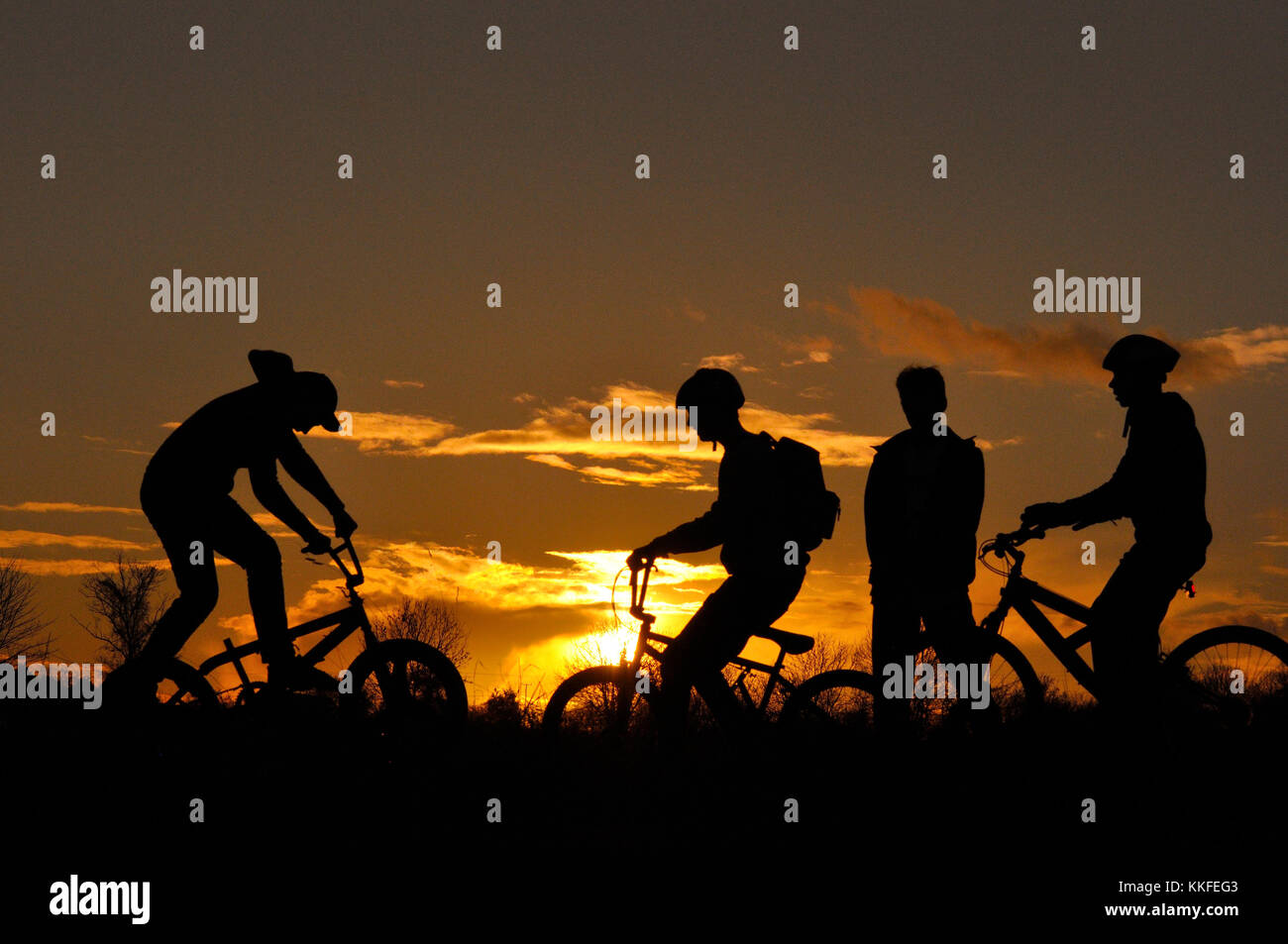 Mountain Bikers in silhouette Stock Photo