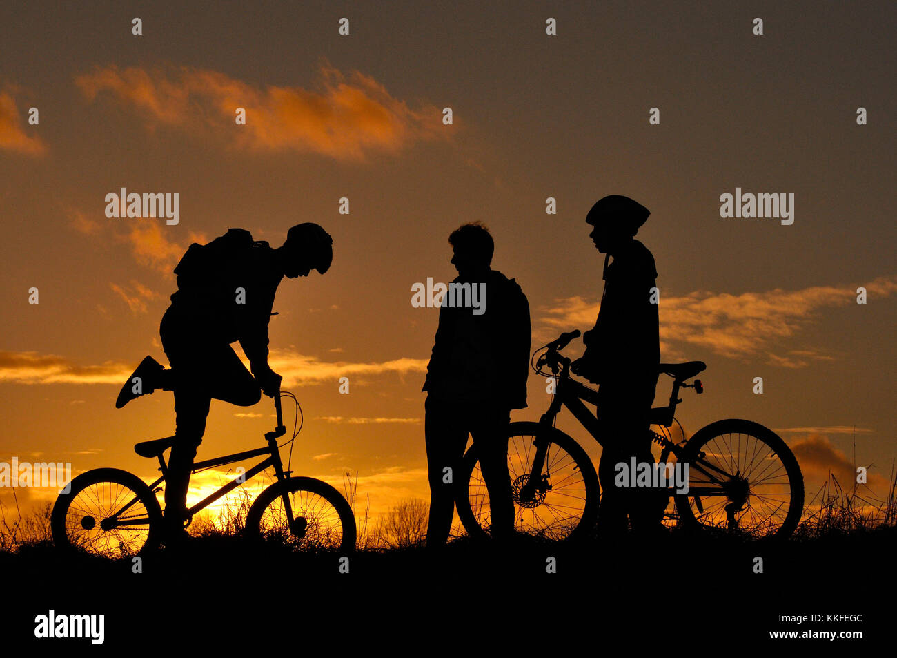 Mountain Bikers in silhouette Stock Photo