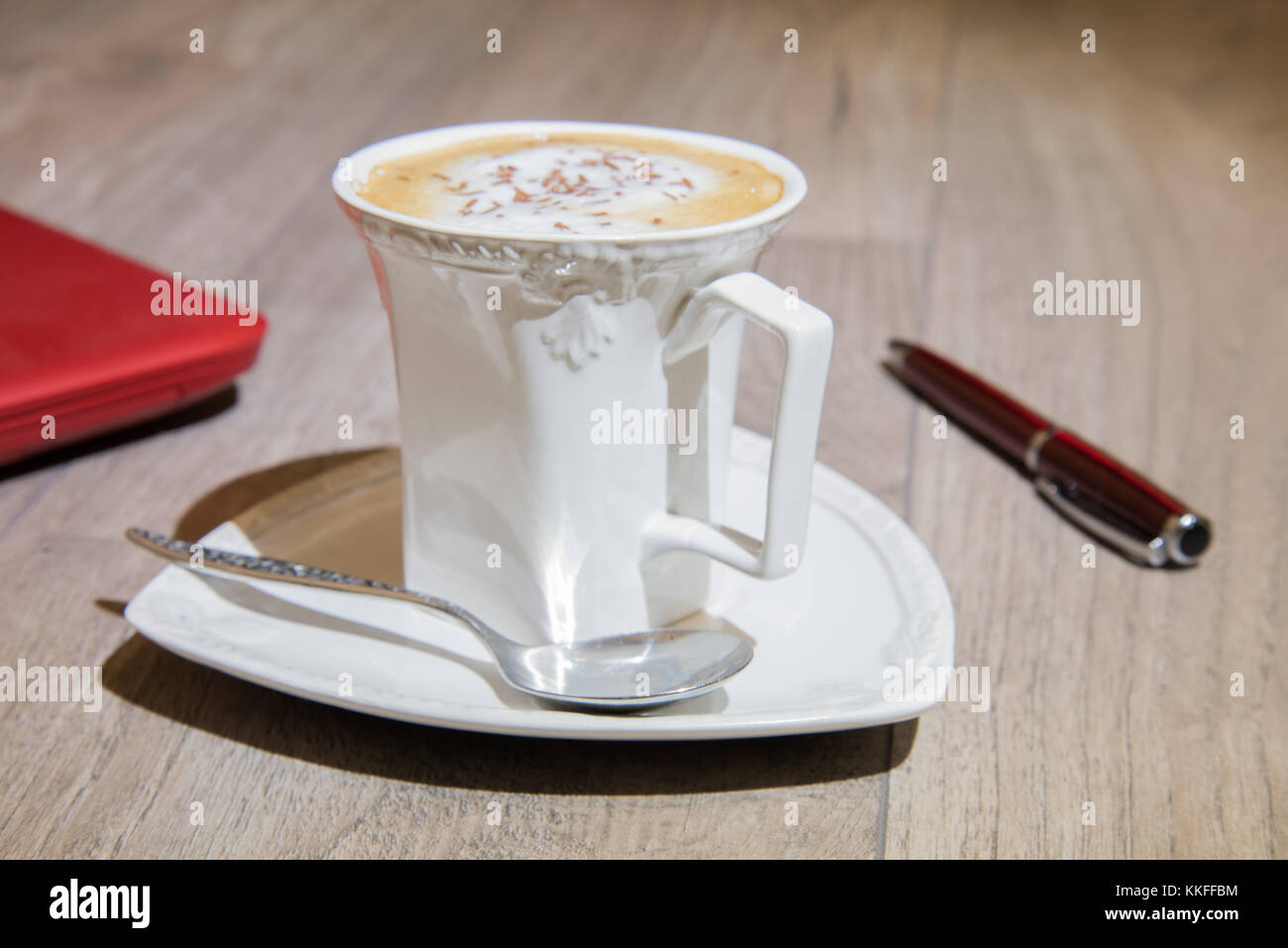 https://c8.alamy.com/comp/KKFFBM/cappuccino-freshly-ground-coffee-in-elegant-white-cup-KKFFBM.jpg