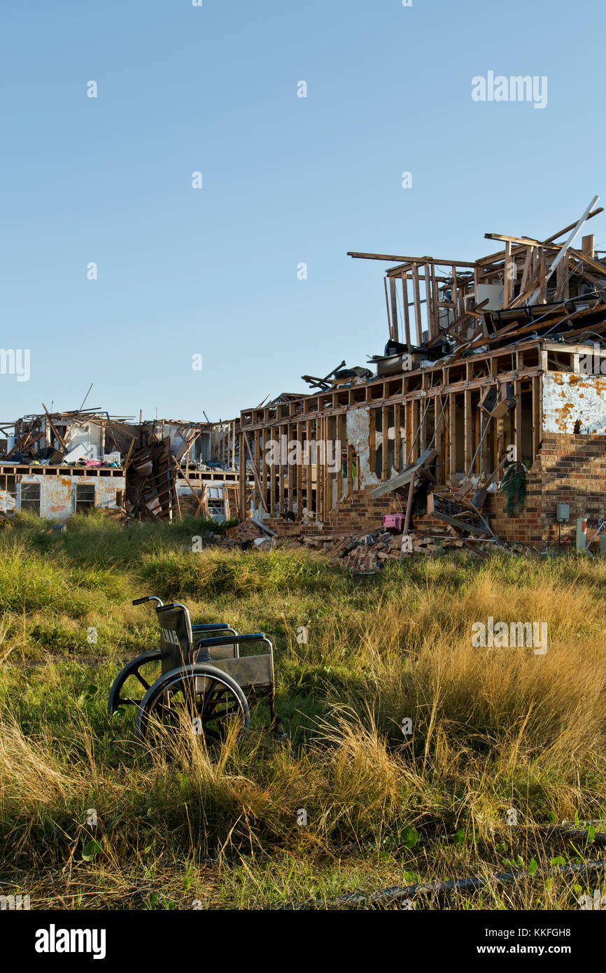 Abandoned wheelchair, setting in common area, destroyed two story apartment units, resulting from hurricane 'Harvey' 2017. Stock Photo