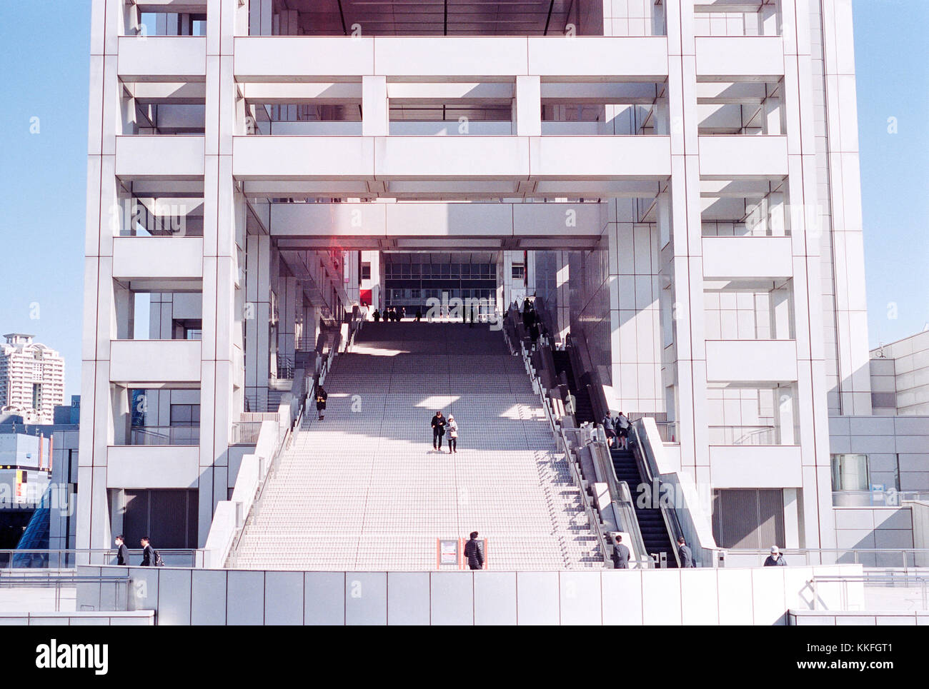 People walking up and down that staircase of the futuristic Fuji TV Building in Odaiba, Japan Stock Photo