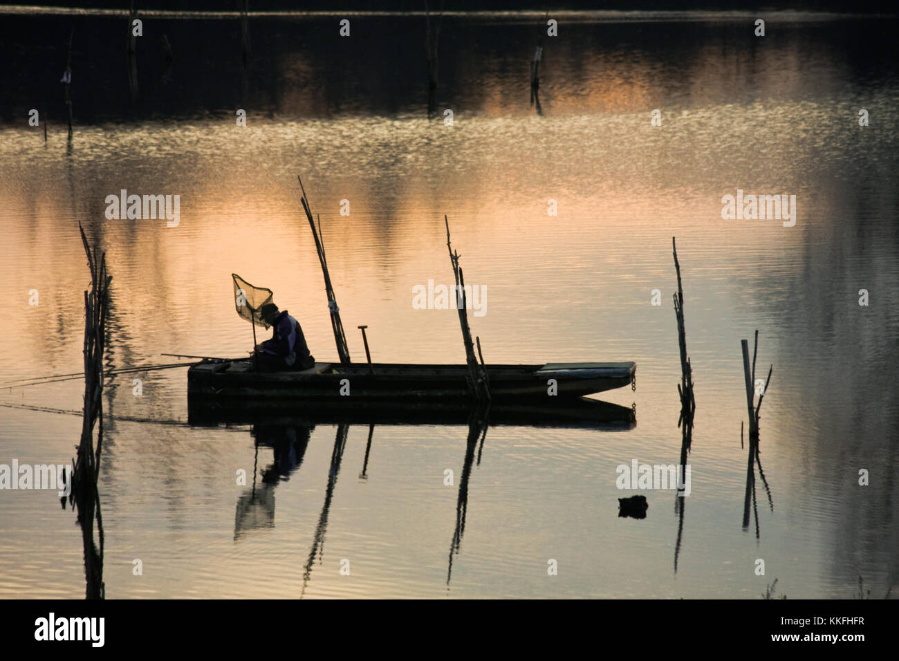 fisherman on the boat on the river in sunset Stock Photo - Alamy