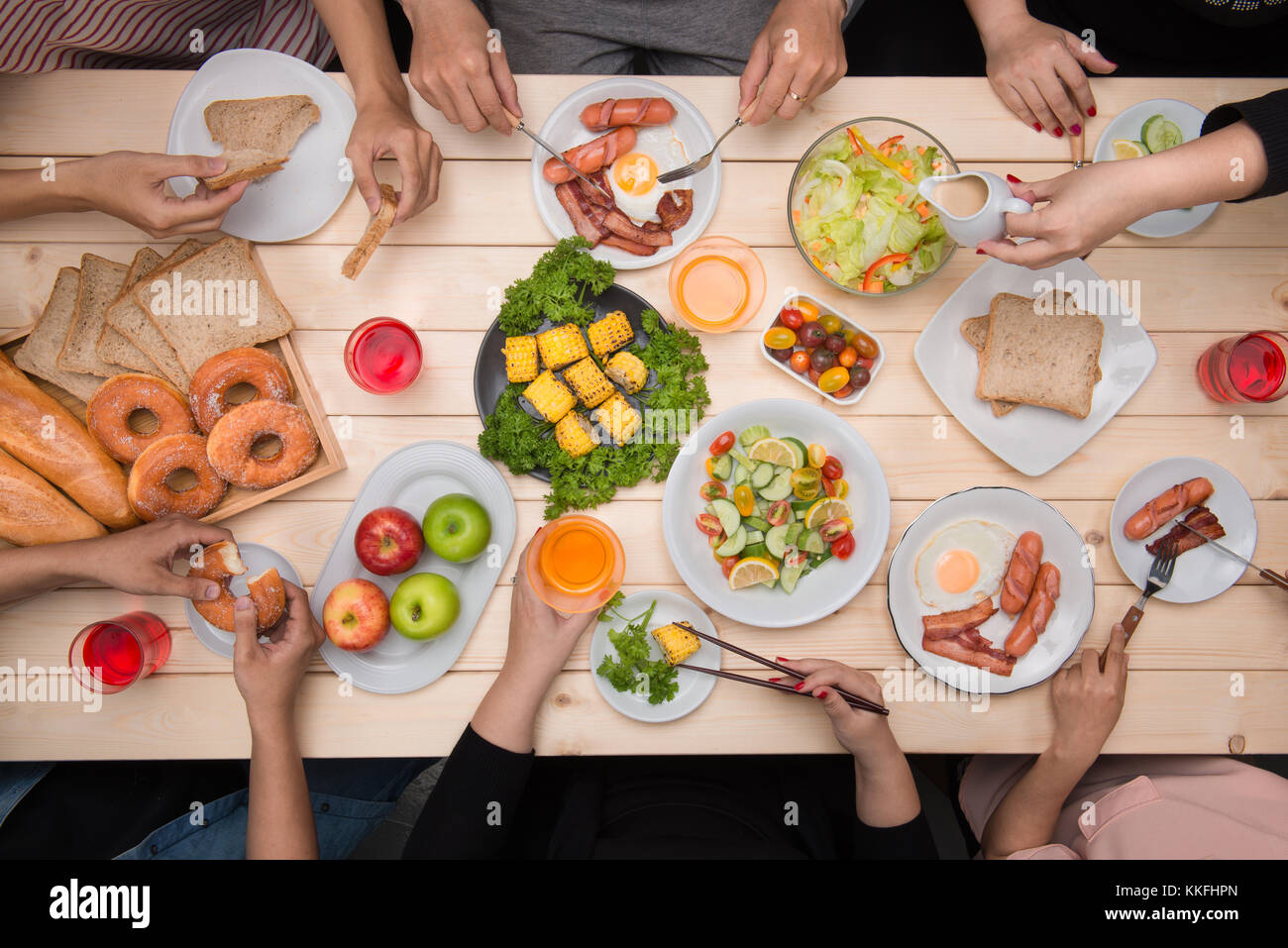 Enjoying dinner with friends. Top view of group of people having dinner