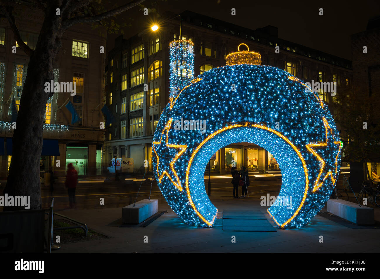 LONDON, UK - NOVEMBER 30, 2017: A gigantic blue bauble decorates Whitfield Gardens, Goodge Street and attracts  Londoners and tourists during the fest Stock Photo