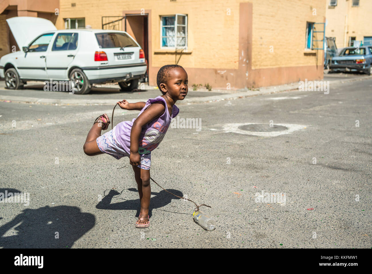 Little girl playing on the street, Langa, Cape Town, South Africa Stock Photo