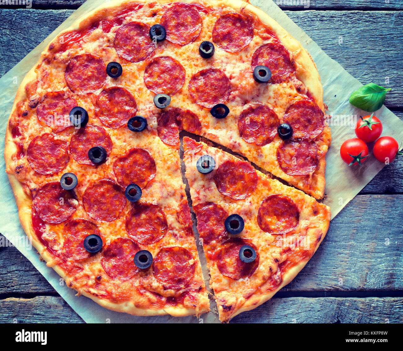 Homemade pepperoni pizza from above on the wooden background Stock Photo