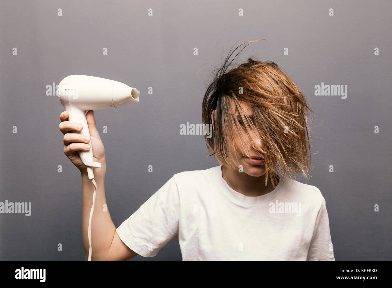 young teenager boy dried hair, grey background Stock Photo - Alamy