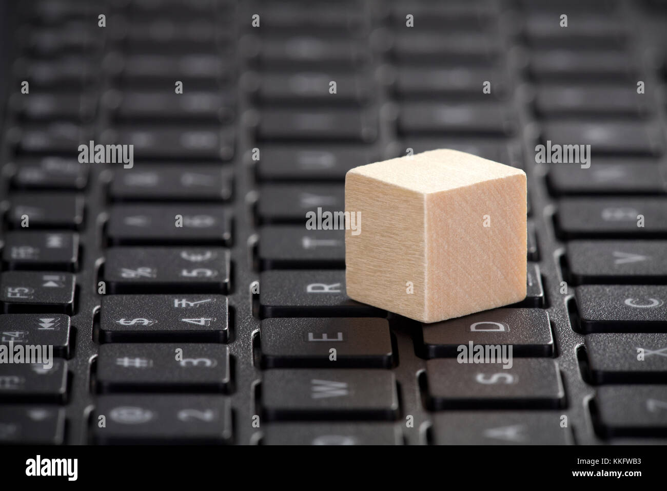 Wooden block on laptop keyboard Stock Photo Alamy