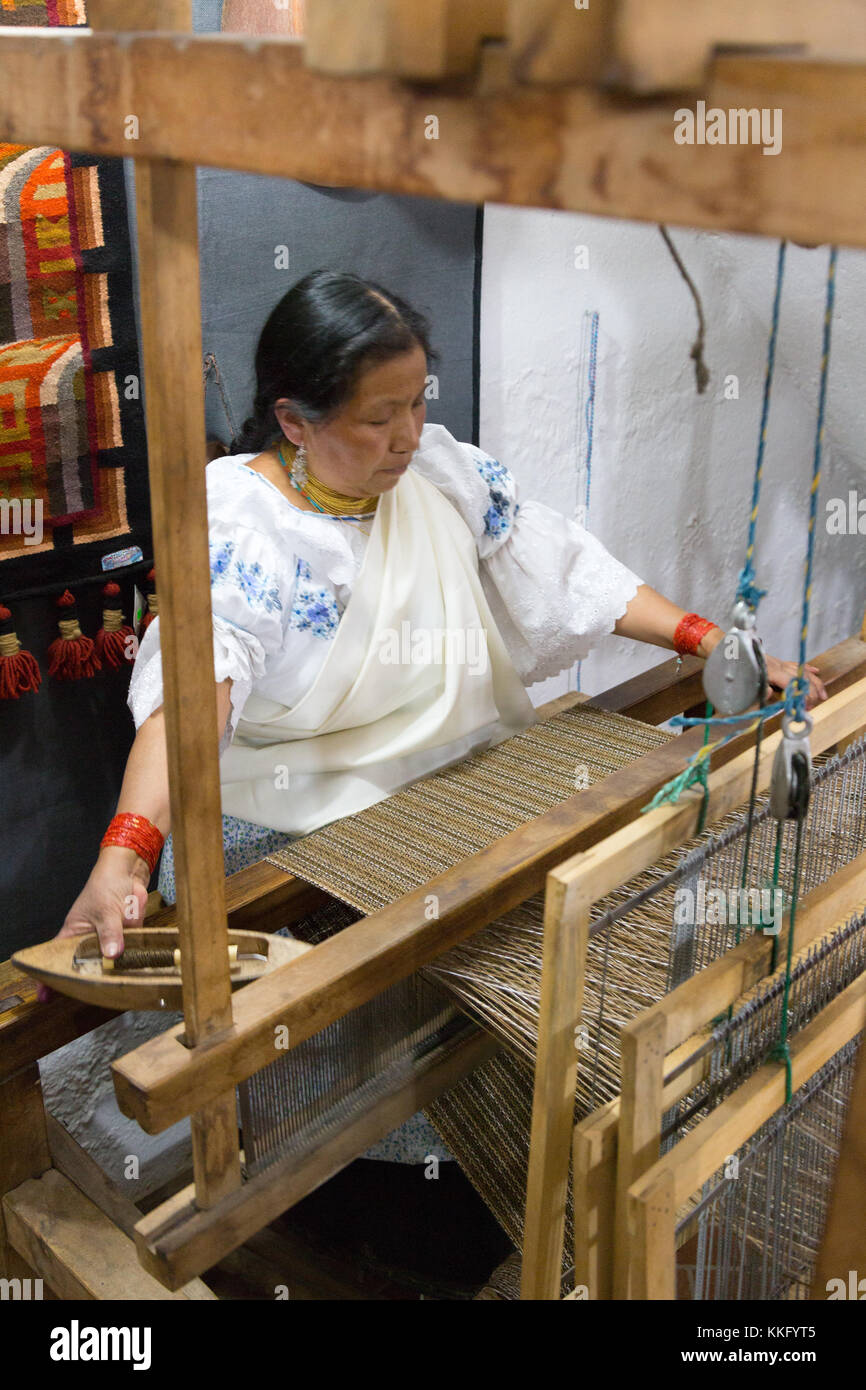 Ecuador Culture - an ecuadorian mature woman using a traditional loom to make textiles, Otavalo, Ecuador, South America Stock Photo
