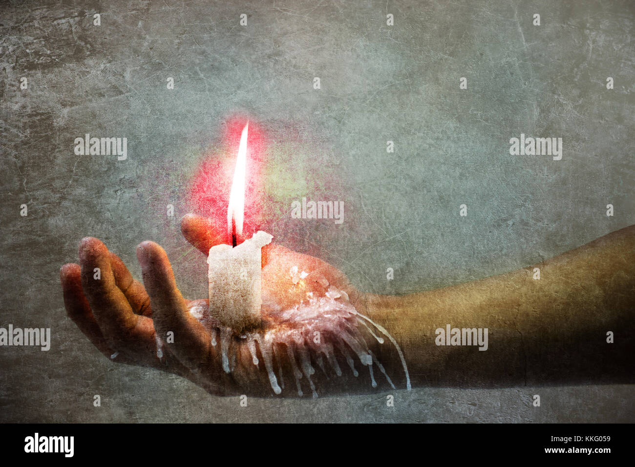A hand holding a burning candle and wax falling down Stock Photo Alamy