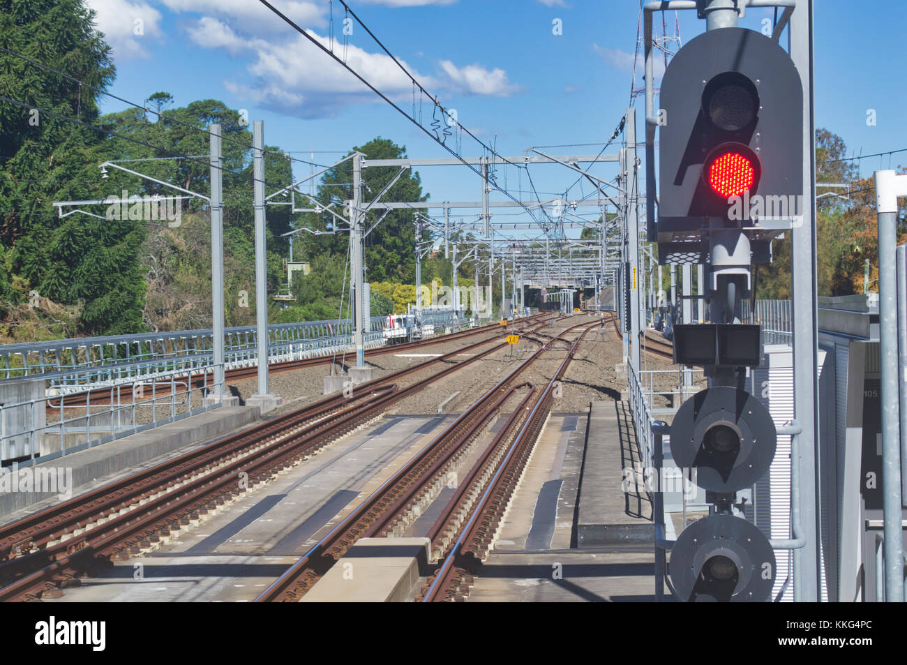 Railroad tracks going to the city as seen from a station platform. Stock Photo