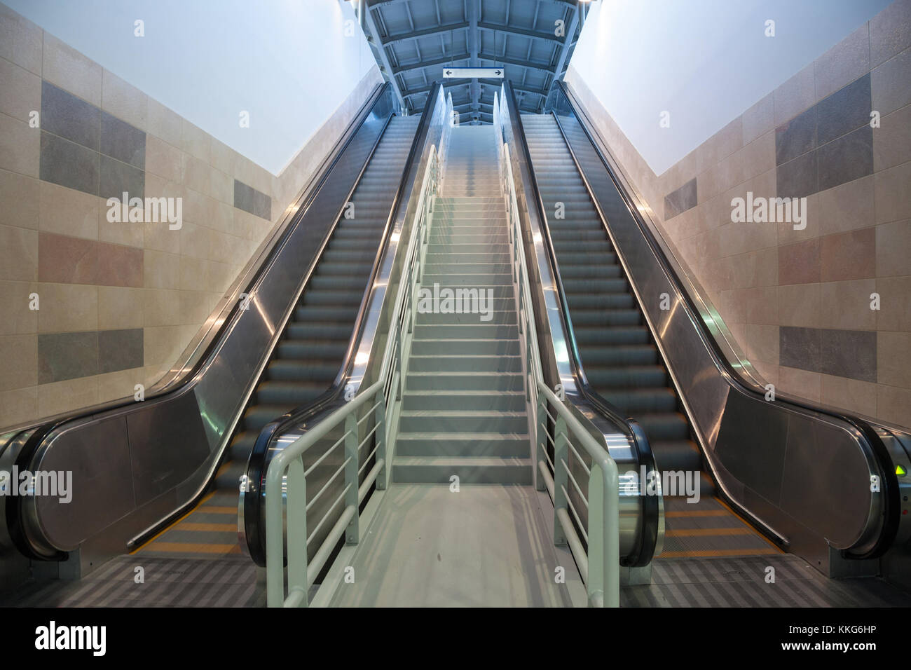 Escalators in movement in a train station, going from the underground to the platform  Picture of mecanical stairs, or escalators, in movementm withou Stock Photo