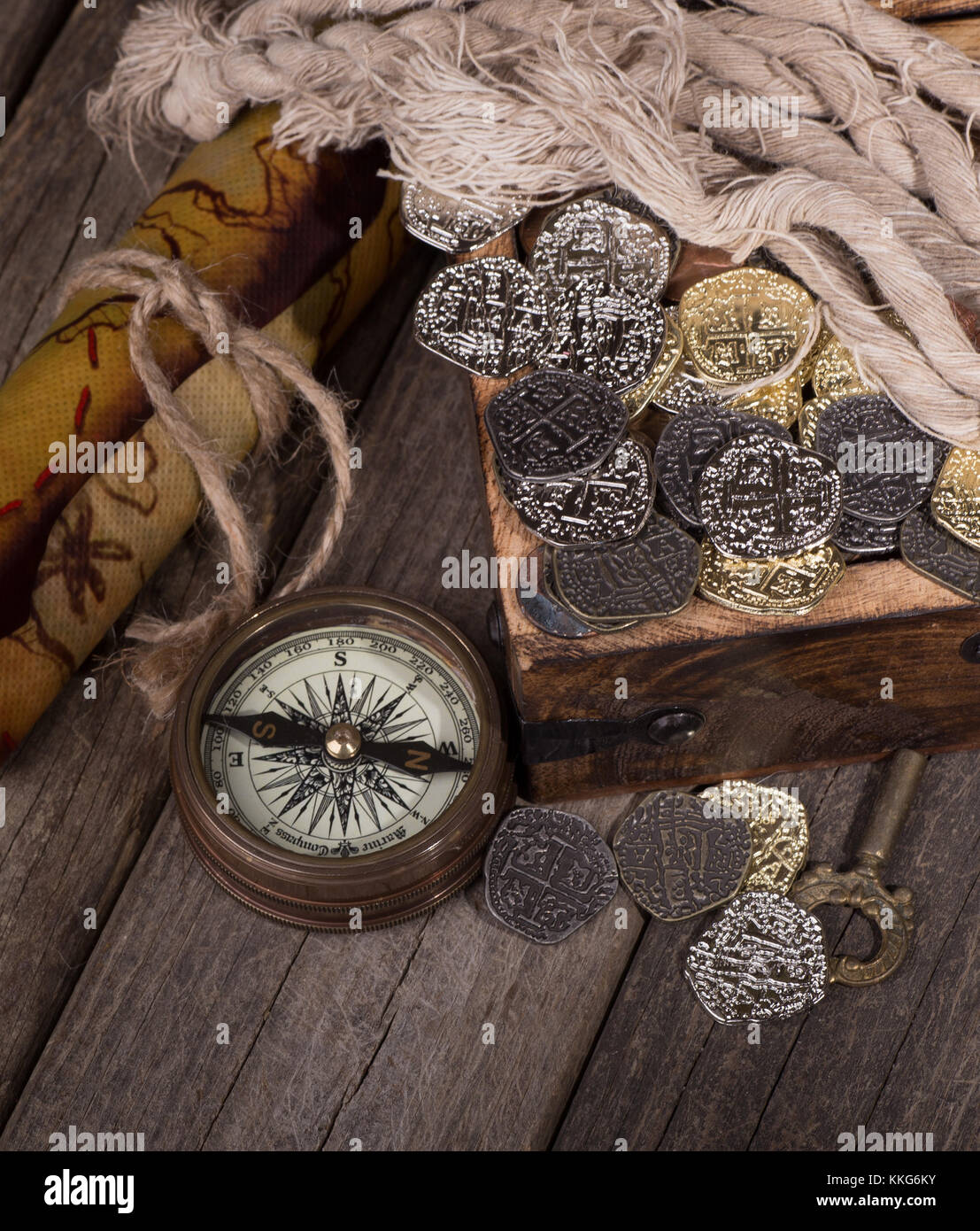 Gold and silver coins in a treaure chest with compass and map Stock ...