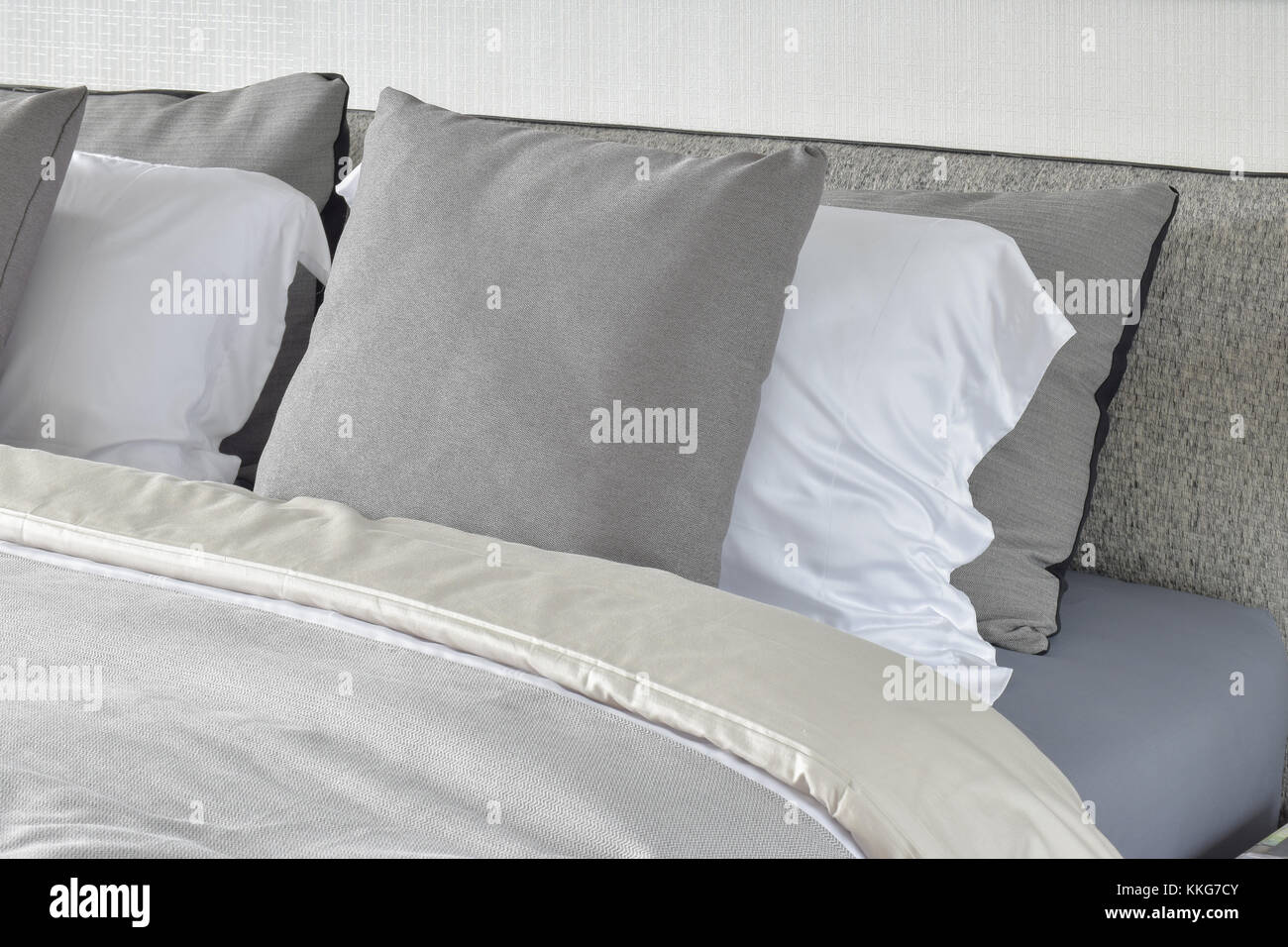 Pillows setting on bed with gray color scheme bedding Stock Photo Alamy
