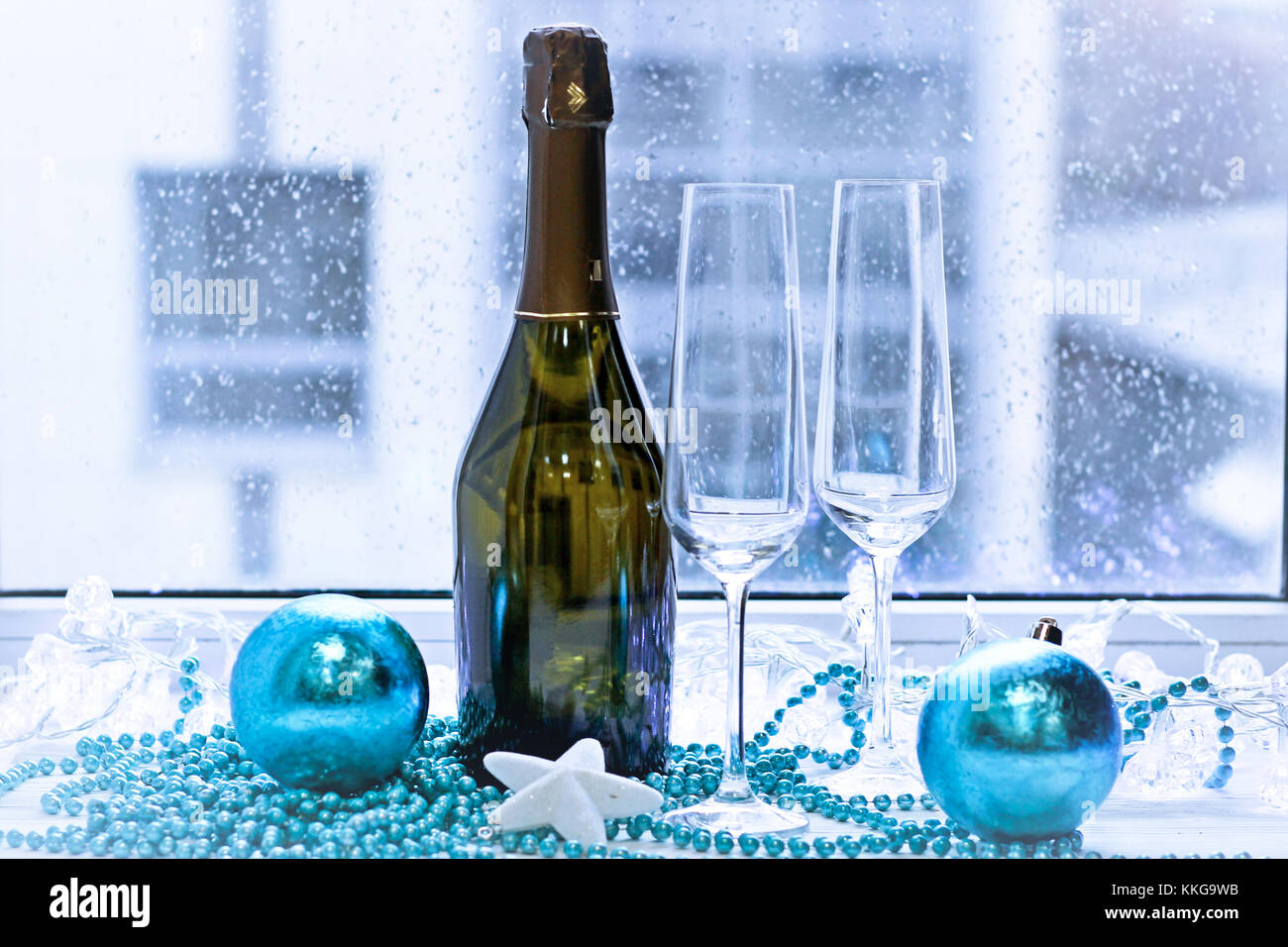 Two glasses, a bottle of champagne and Christmas-tree decorations Stock ...