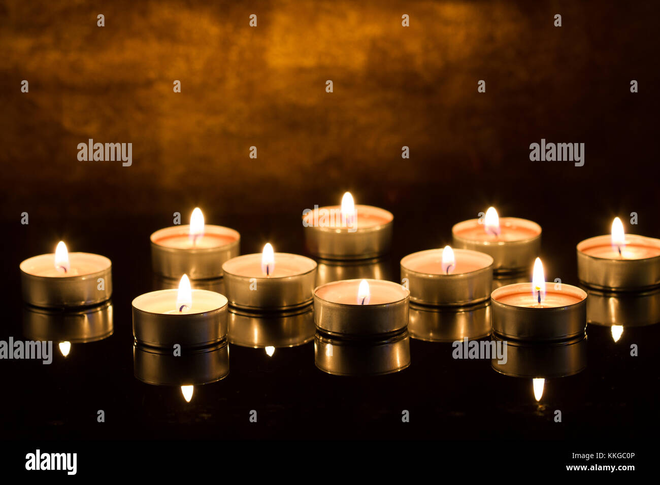 Burning candles on dark background Stock Photo - Alamy