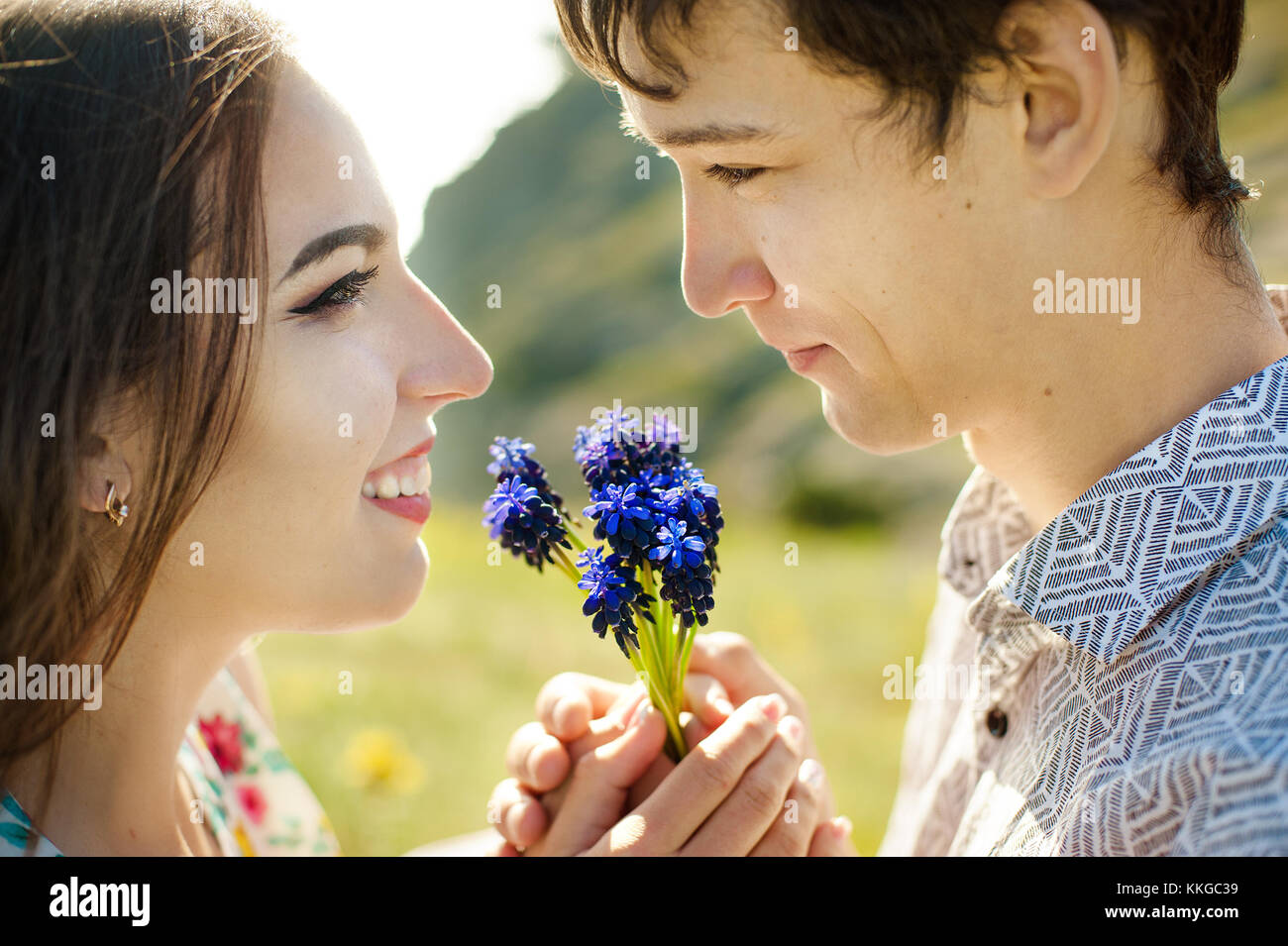 A picture of a man giving flowers to his lover on a summer day Stock