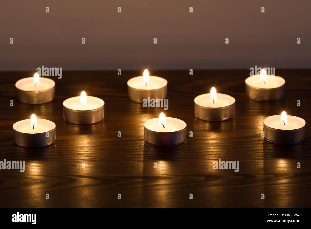 Burning candles on dark background Stock Photo - Alamy