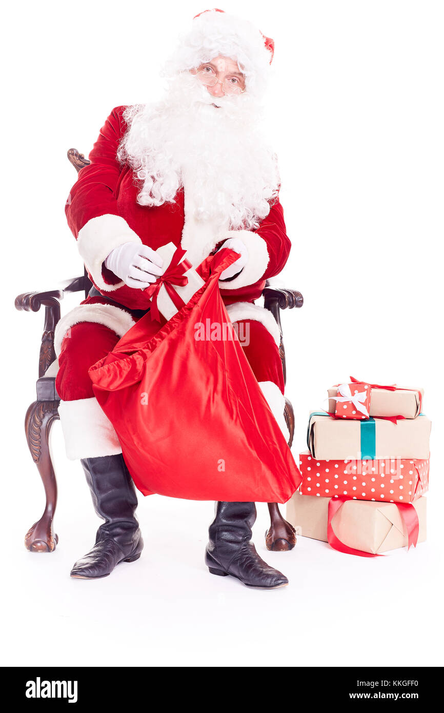 Santa Claus packing his sack Stock Photo - Alamy