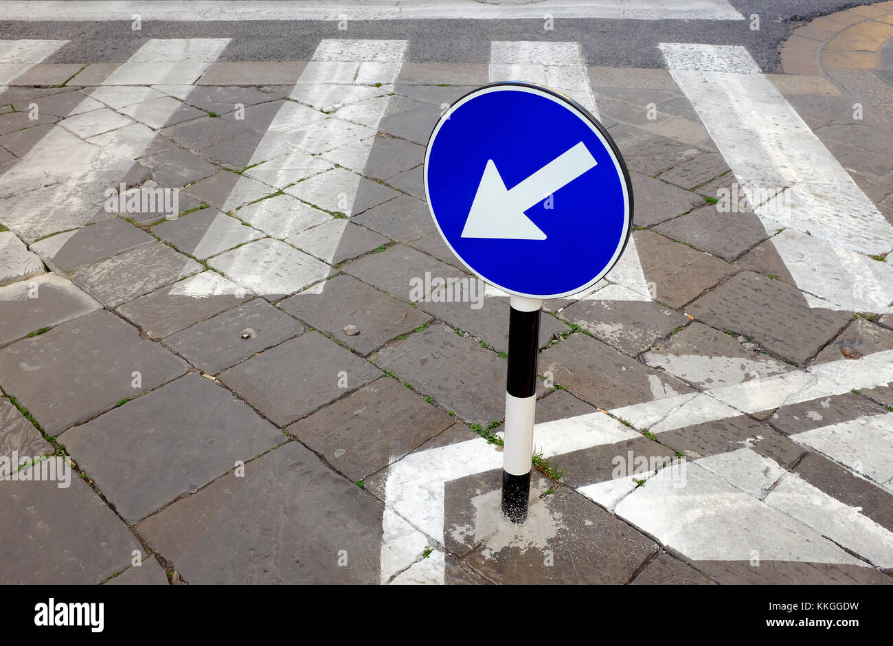 directional arrow on road crossing, florence, italy Stock Photo
