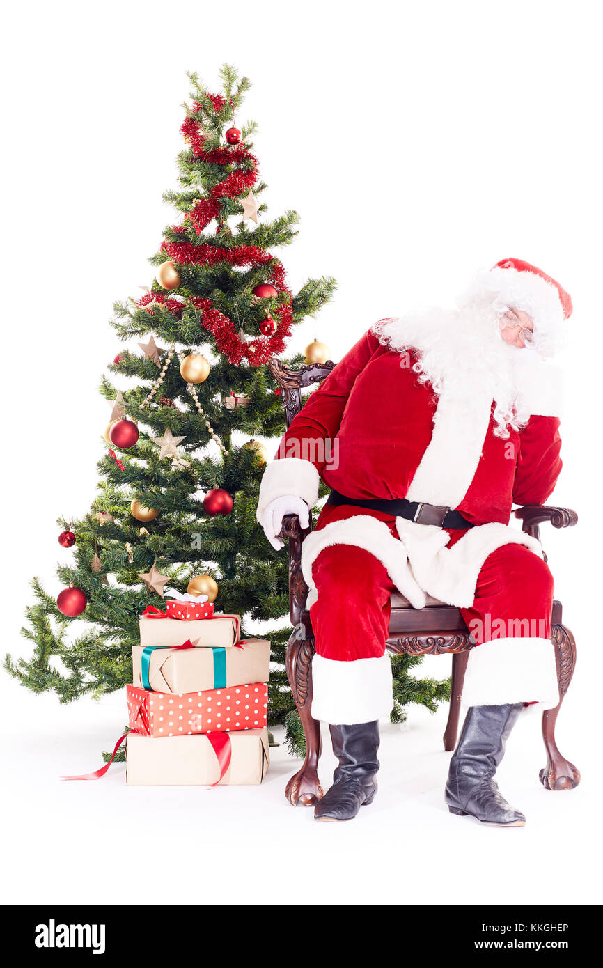 Santa sleeping near Christmas tree Stock Photo