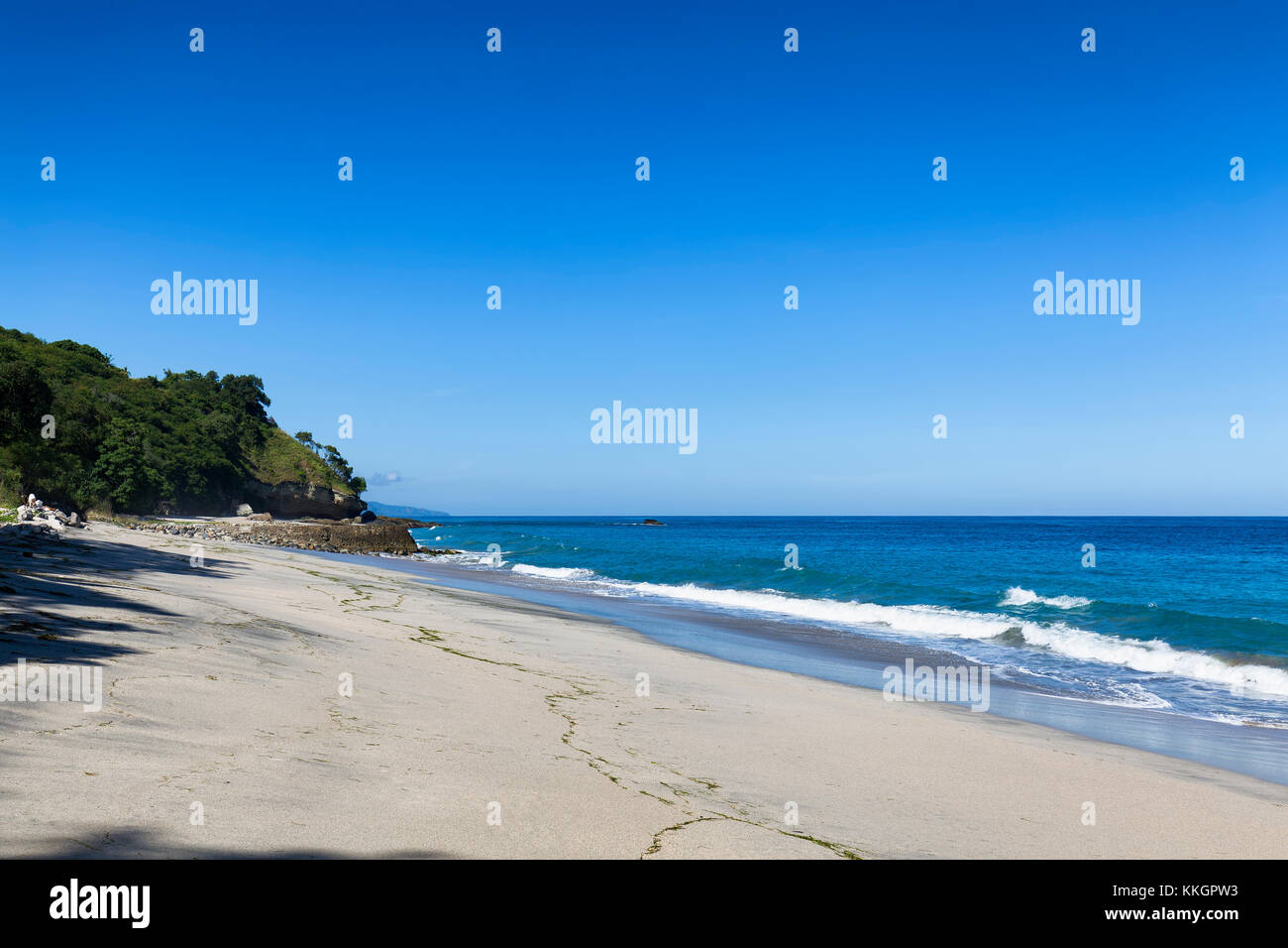 Low tide on a beautiful cloudless afternoon in Paga, Sikka Regency, East Nusa Tenggara, Indonesia. Stock Photo