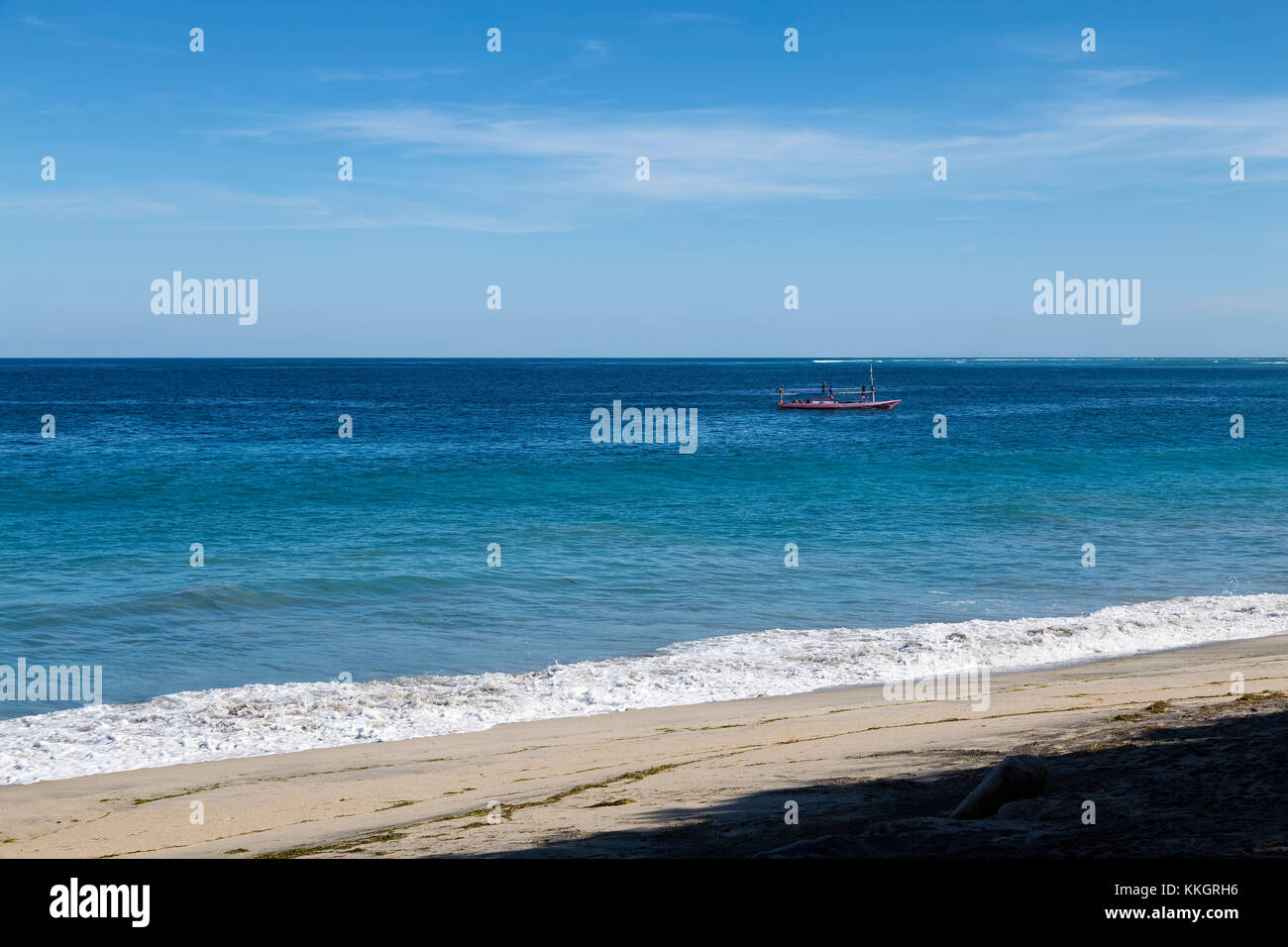 A fishing boat off the empty beach in Paga, East Nusa Tenggara, Indonesia. Stock Photo