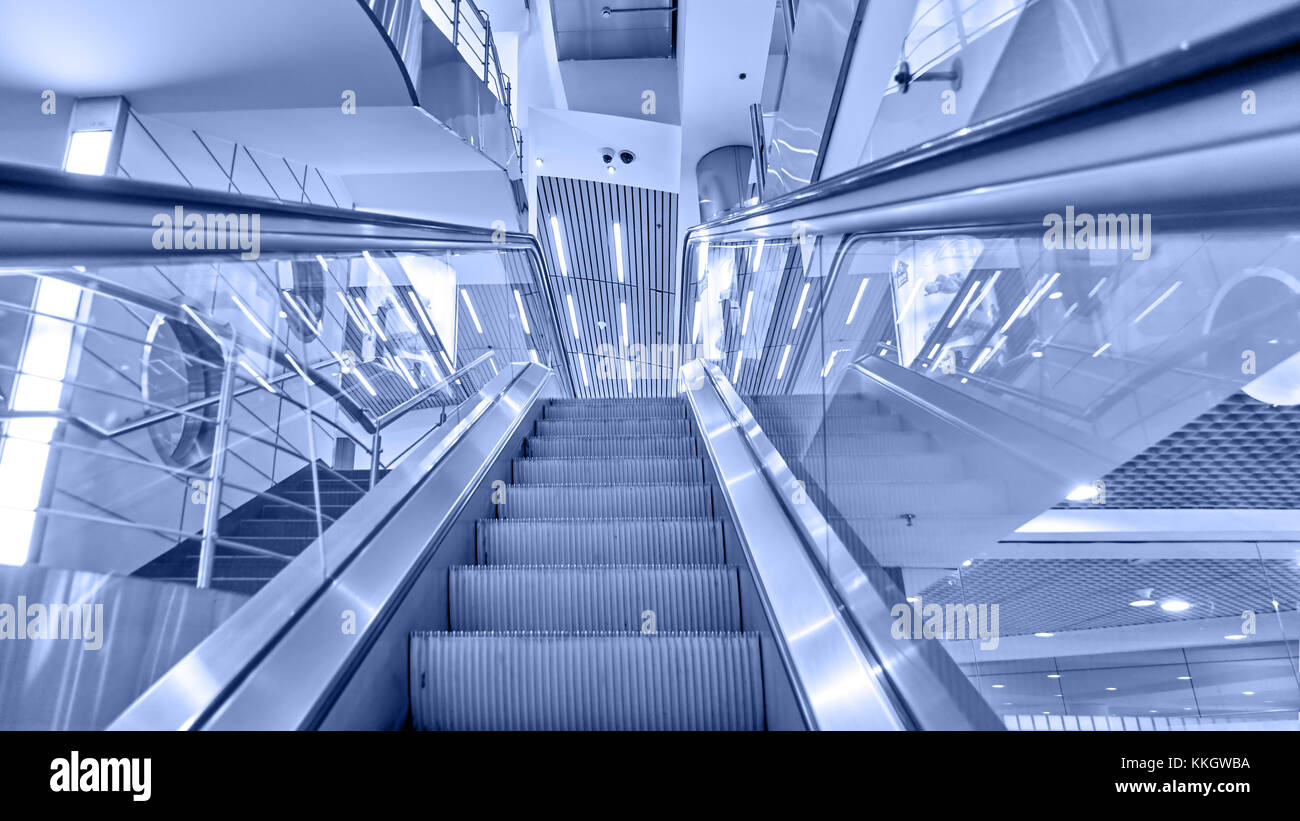 Perspective of escalator toned in blue color Stock Photo