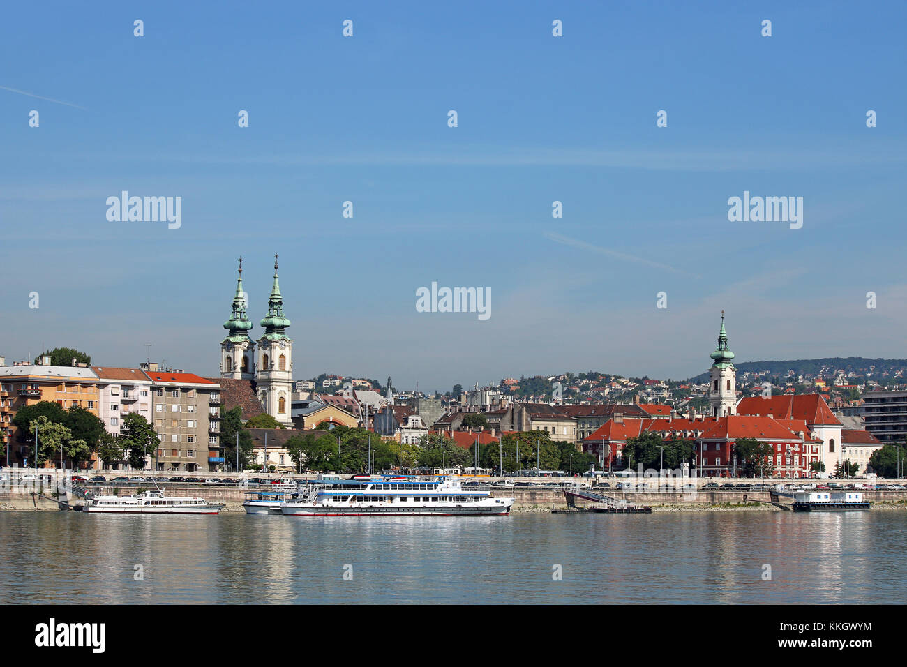 Danube riverside with churches buildings and boats Budapest Hungary