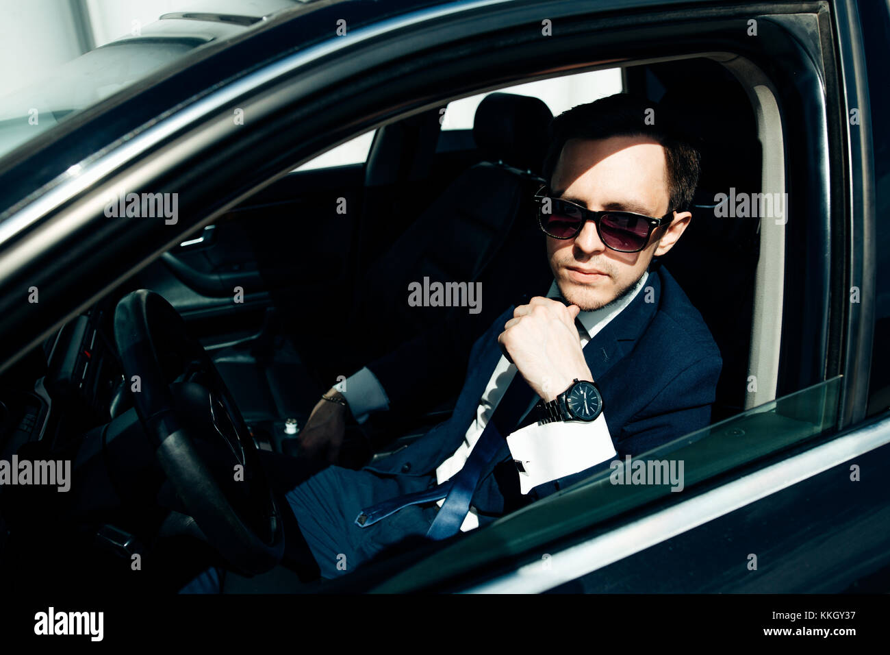 Portrait of an handsome smiling business man driving his car Stock ...