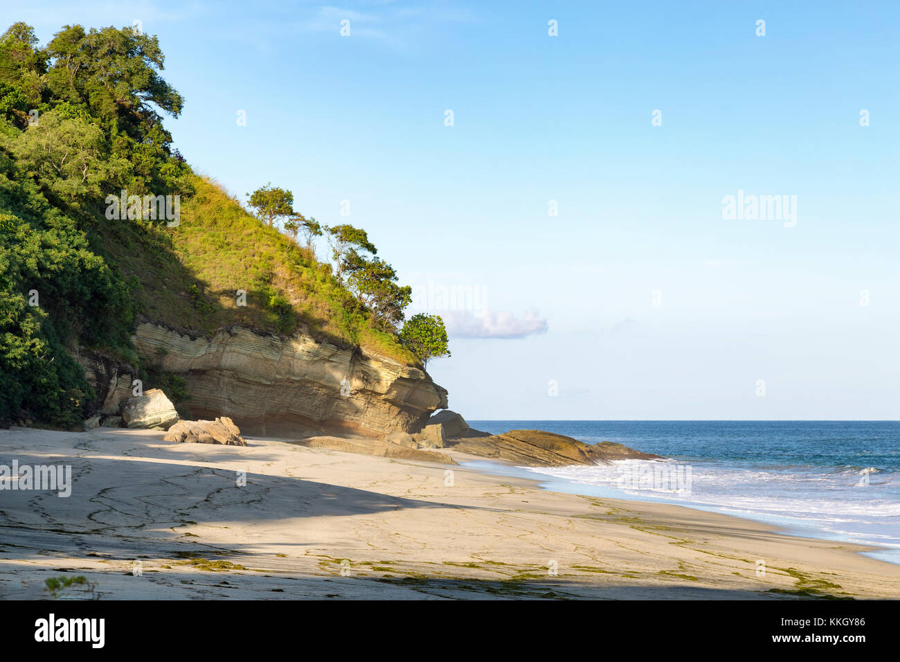 Surf slowly shapes a small hill at the end of the beach in Paga, East Nusa Tenggara, Indonesia. Stock Photo