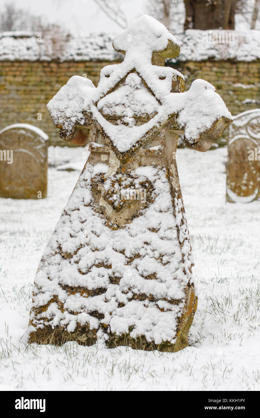 Graveyard headstones covered with snow. Now resembling a smiling face