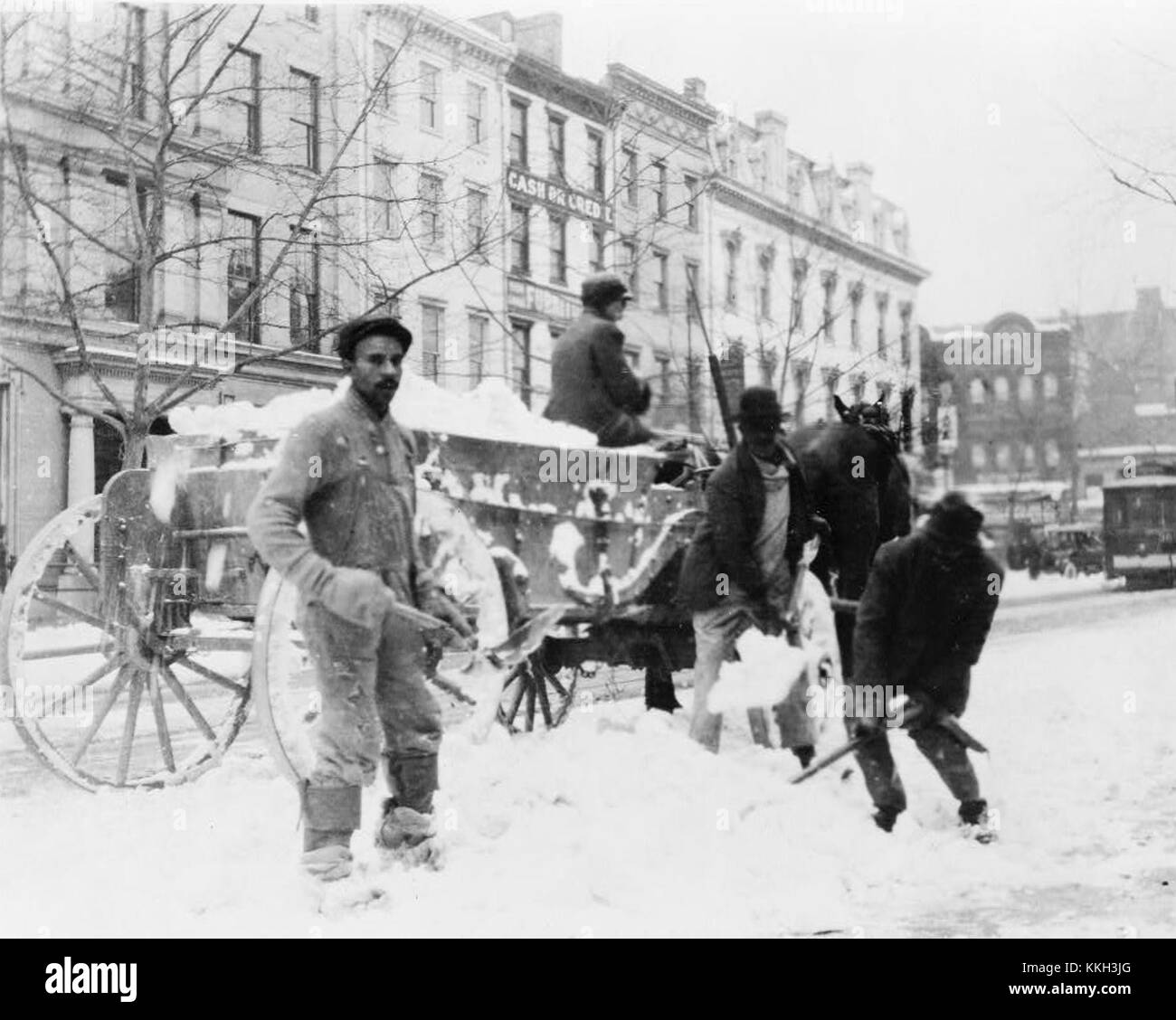 Men loading Snow onto wagon, after Snow Storm 3c09360v Stock Photo