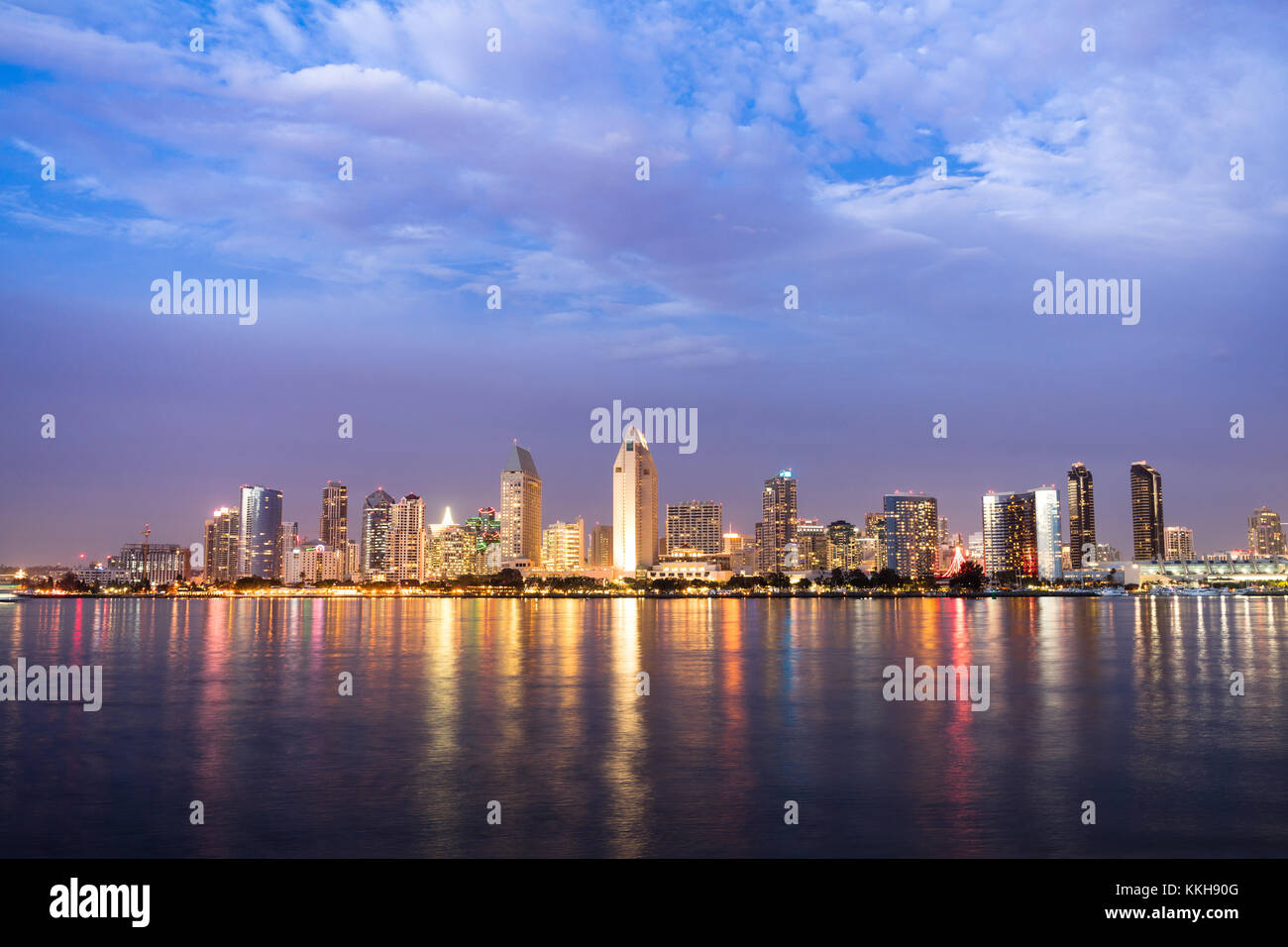 Night falls on San Diego California as the bay reflects lights from