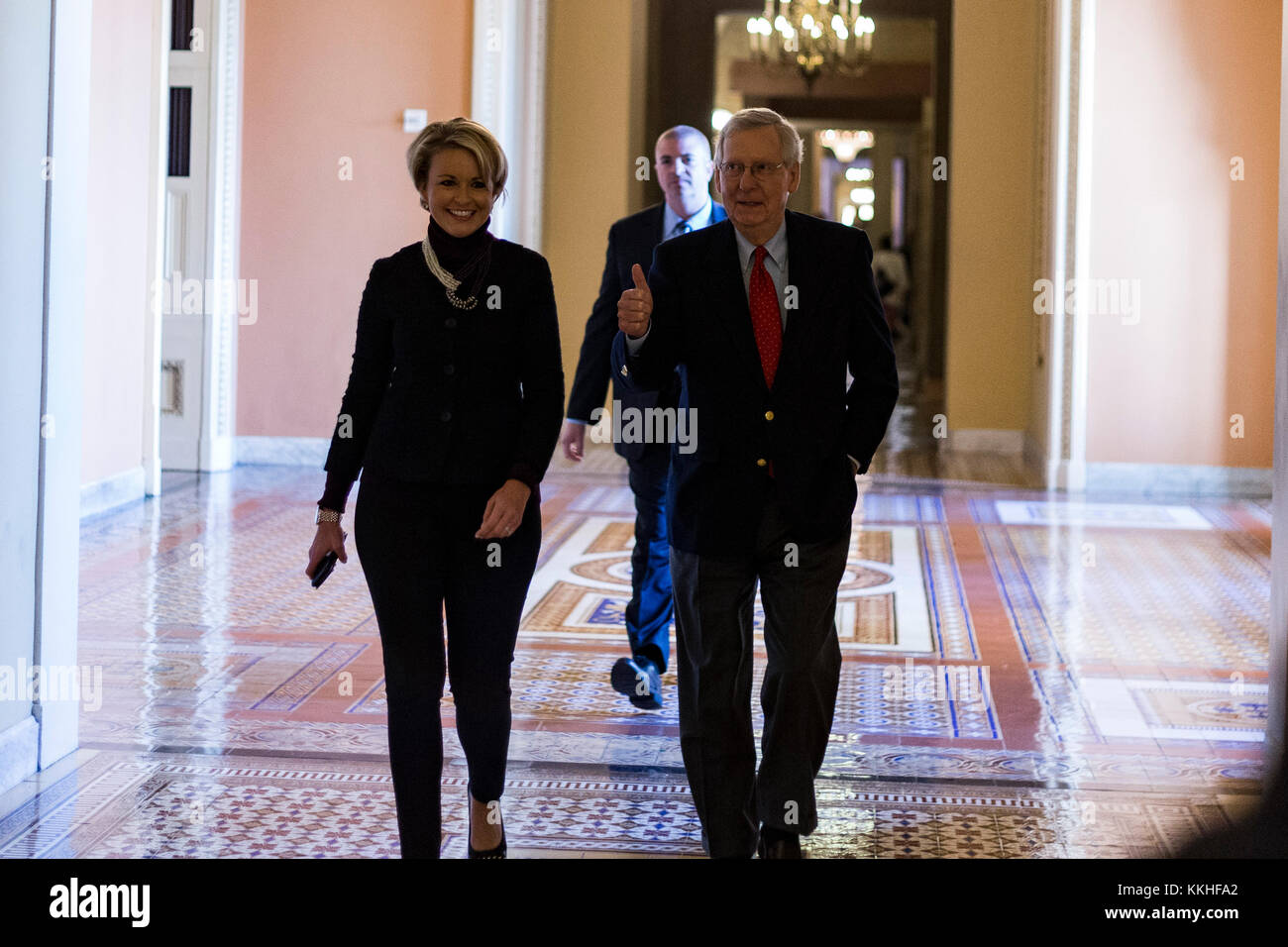 United States Senate Majority Leader Mitch McConnell (Republican of Kentucky) gives a thumbs up as he walks with a staffer from his office to the Senate chamber for a procedural vote to move forward with voting on the Republican proposed tax reform bill at the United States Capitol in Washington, DC on Friday, December 1, 2017. Credit: Alex Edelman/CNP /MediaPunch Stock Photo