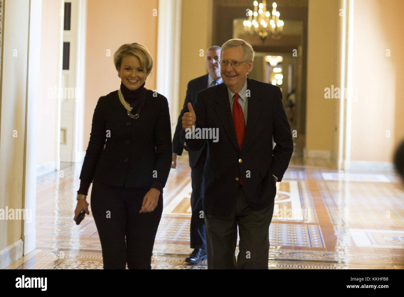 Washington, District of Columbia, USA. 1st Dec, 2017. United States Senate Majority Leader MITCH MCCONNELL (Republican of Kentucky) gives a thumbs up as he walks with a staffer from his office to the Senate chamber for a procedural vote to move forward with voting on the Republican proposed tax reform bill at the United States Capitol. Credit: Alex Edelman/CNP/ZUMA Wire/Alamy Live News Stock Photo