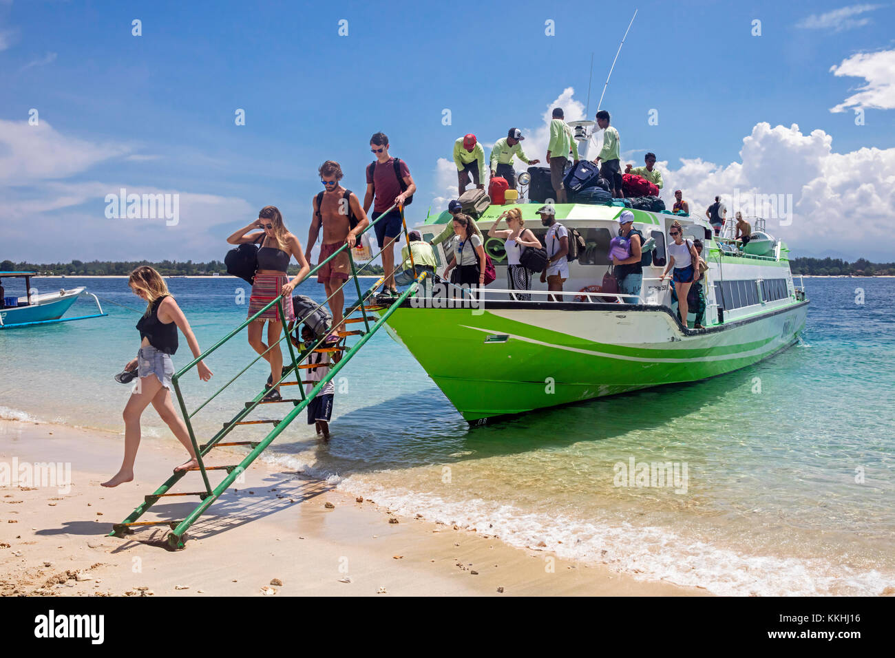 Western tourists debarking from speedboat / fast boat on the island Gili Trawangan, largest of Lombok's Gili Islands, Indonesia Stock Photo