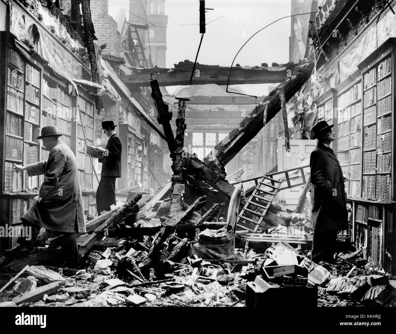 HOLLAND HOUSE, Kensington, London. An interior view of the bombed library at Holland House with readers apparently choosing books regardless of the damage. Photographed in 1940. The House was heavily bombed during World War II and remained derelict until 1952 when parts of the remains were preserved. Holland House, originally known as Cope Castle, was a great house in Kensington in London, situated in what is now Holland Park. Created in 1605 in the Elizabethan or Jacobean style for the diplomat Sir Walter Cope, the building later passed to the powerful Rich family, then the Fox family, under Stock Photo